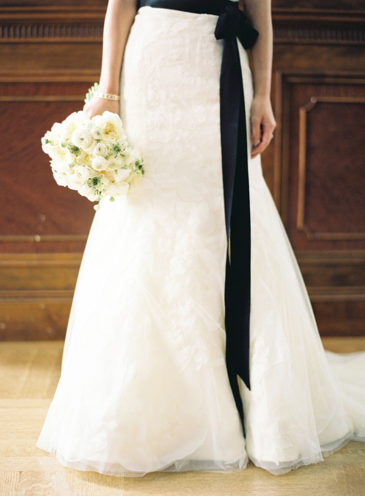 Beautiful Wedding Dress with black sash and bouquet